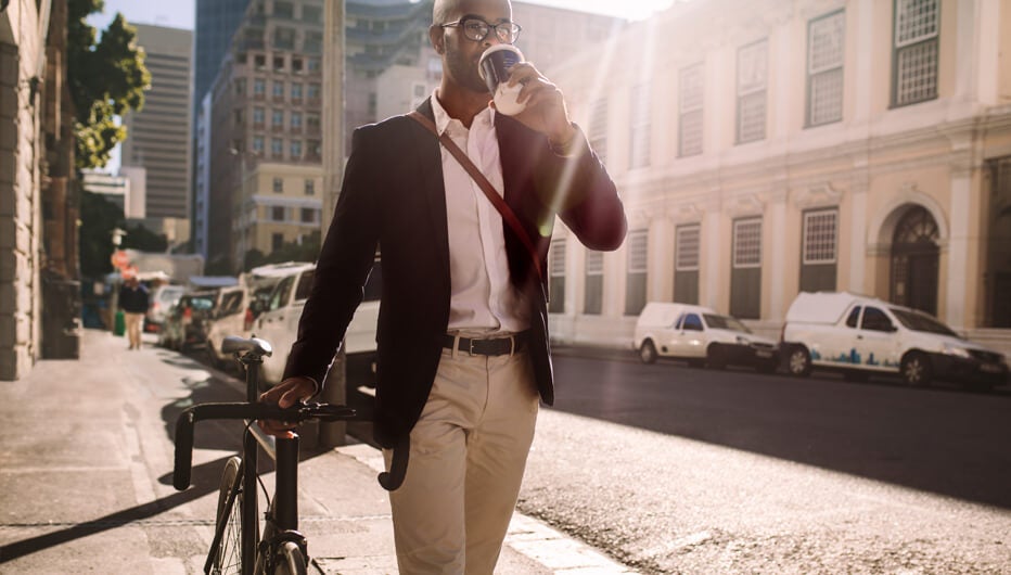 Man drinking coffee walking